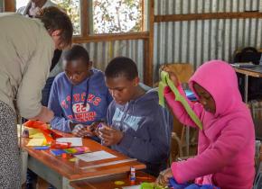 Kids and team member in Kenya in 2018